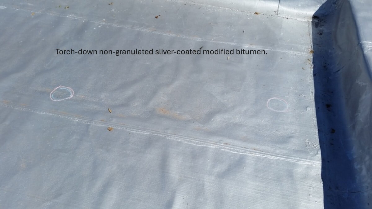 A silver-coated non-granulated modified bitumen roof.